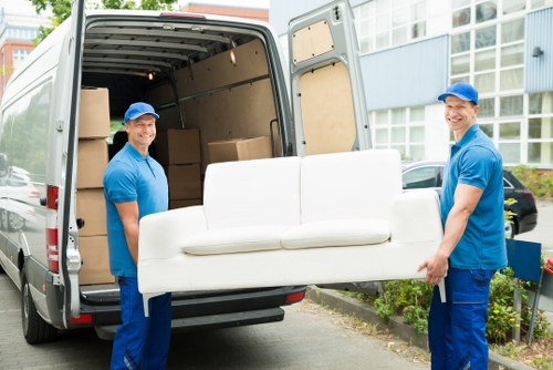 Moving boxes and furniture in a Balham street