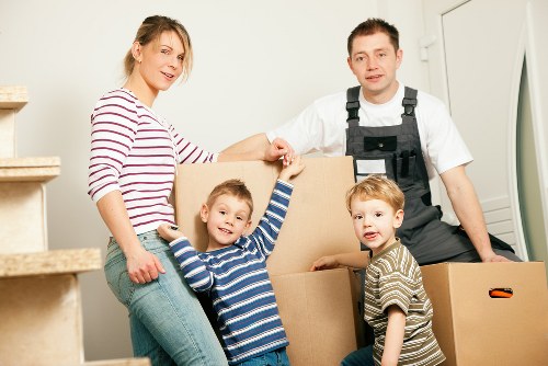 Professional movers packing boxes for a home relocation in Balham