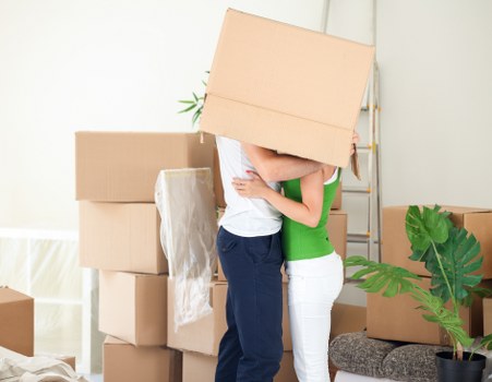 Professional movers carrying furniture during a Balham house move
