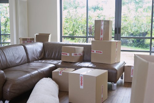 Packed moving boxes and furniture ready for transport in Balham