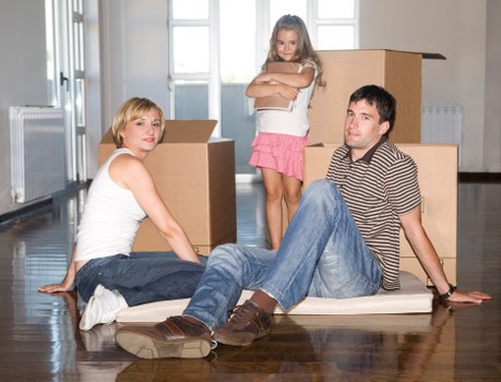 Professional movers handling desks and IT equipment during an office move